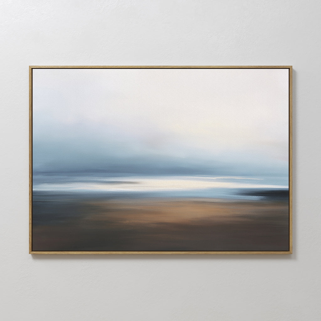 The Blurred Seascape Canvas Art - Horizontal features soft blends of blue, white, and brown, creating a dreamy coastal vibe with its gentle horizon and serene hues. This abstract wall art adds tranquility to any space when hung on a plain white wall.