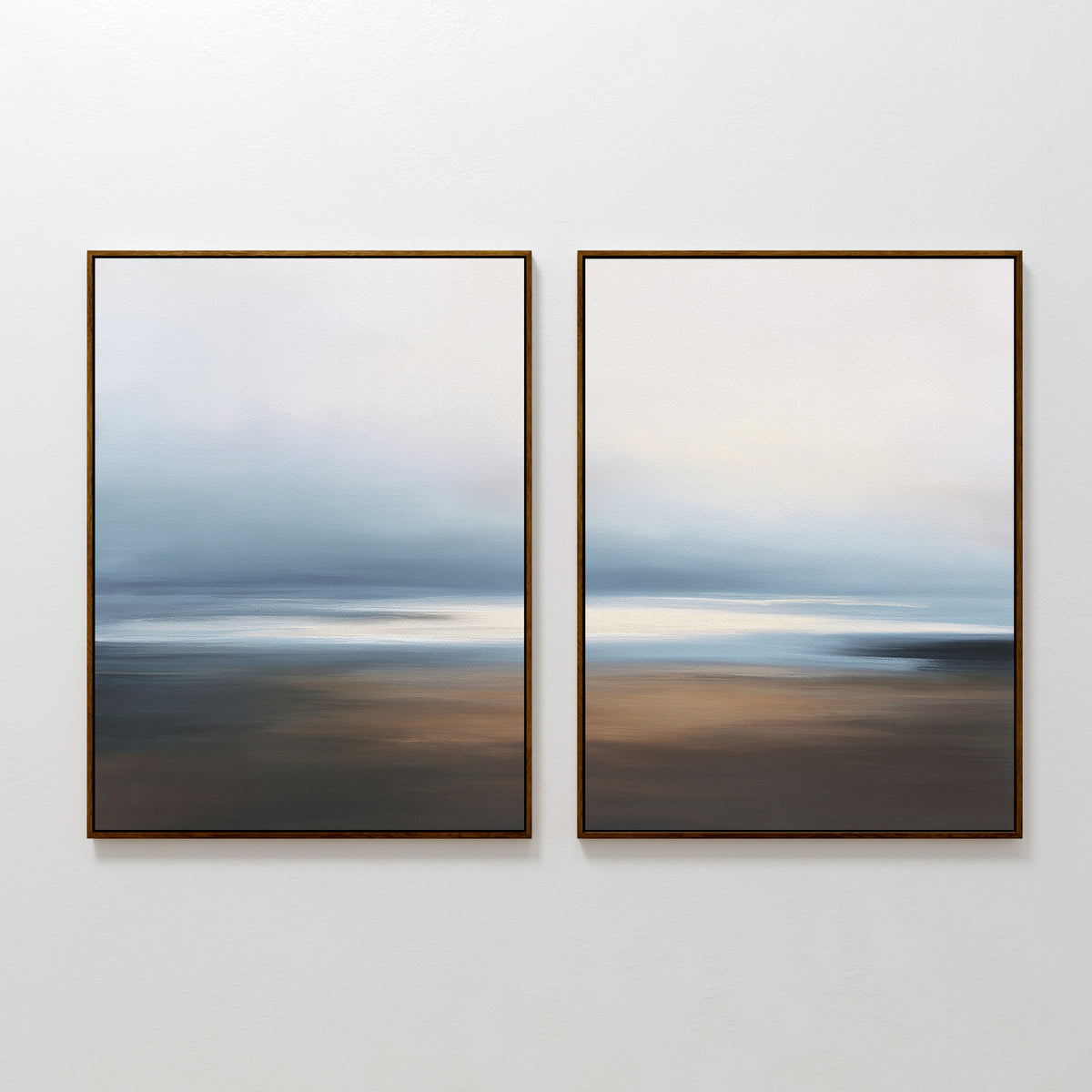 The Blurred Seascape - Set Of 2 features abstract wall art with soft blue, white, and brown hues. Framed and hung together, they bring a serene coastal vibe to any space.