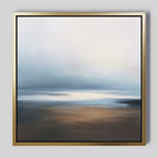 Blurred Seascape Canvas Art - Square: A gold-framed abstract painting with soft blues, whites, browns, and beiges, evoking a serene misty sky and reflective water for a tranquil atmosphere.