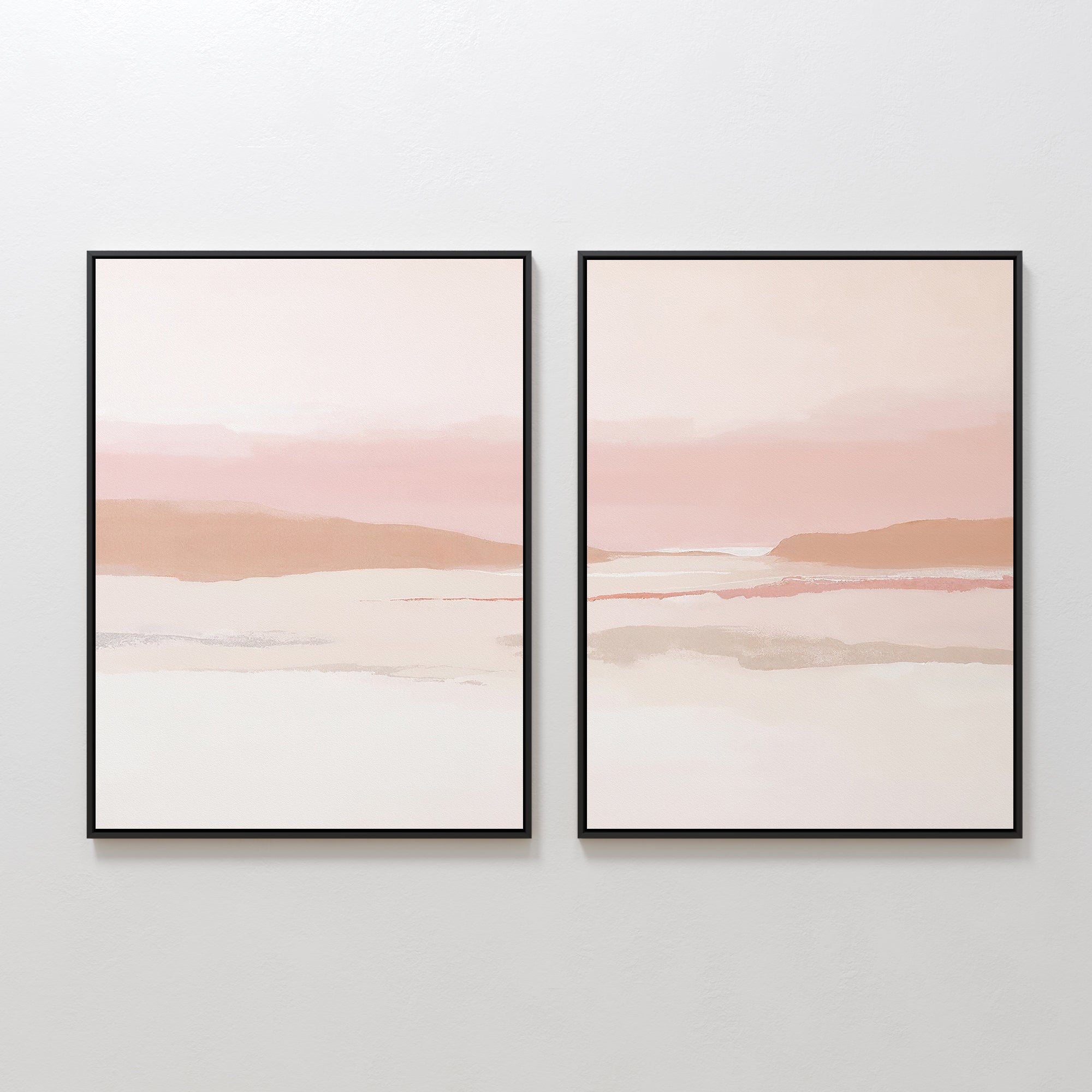 The Blush Mesa - Set Of 2 features framed abstract landscape prints in soft pastel earth tones of pink, beige, and white, creating a serene minimalist wall art scene under a light sky when hung side by side on a white wall.