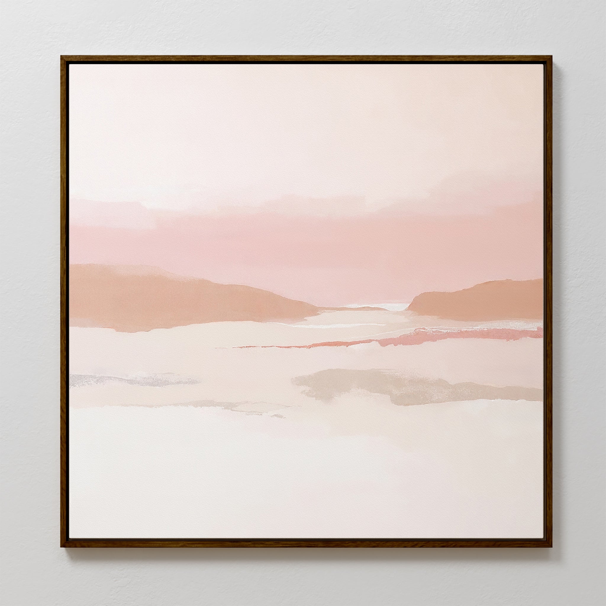 The Blush Mesa Canvas Art - Square features an abstract landscape in soft pink, beige, and white tones with distant hills and a calm sky, set in a sleek dark wooden frame—ideal for bringing tranquility to any space.
