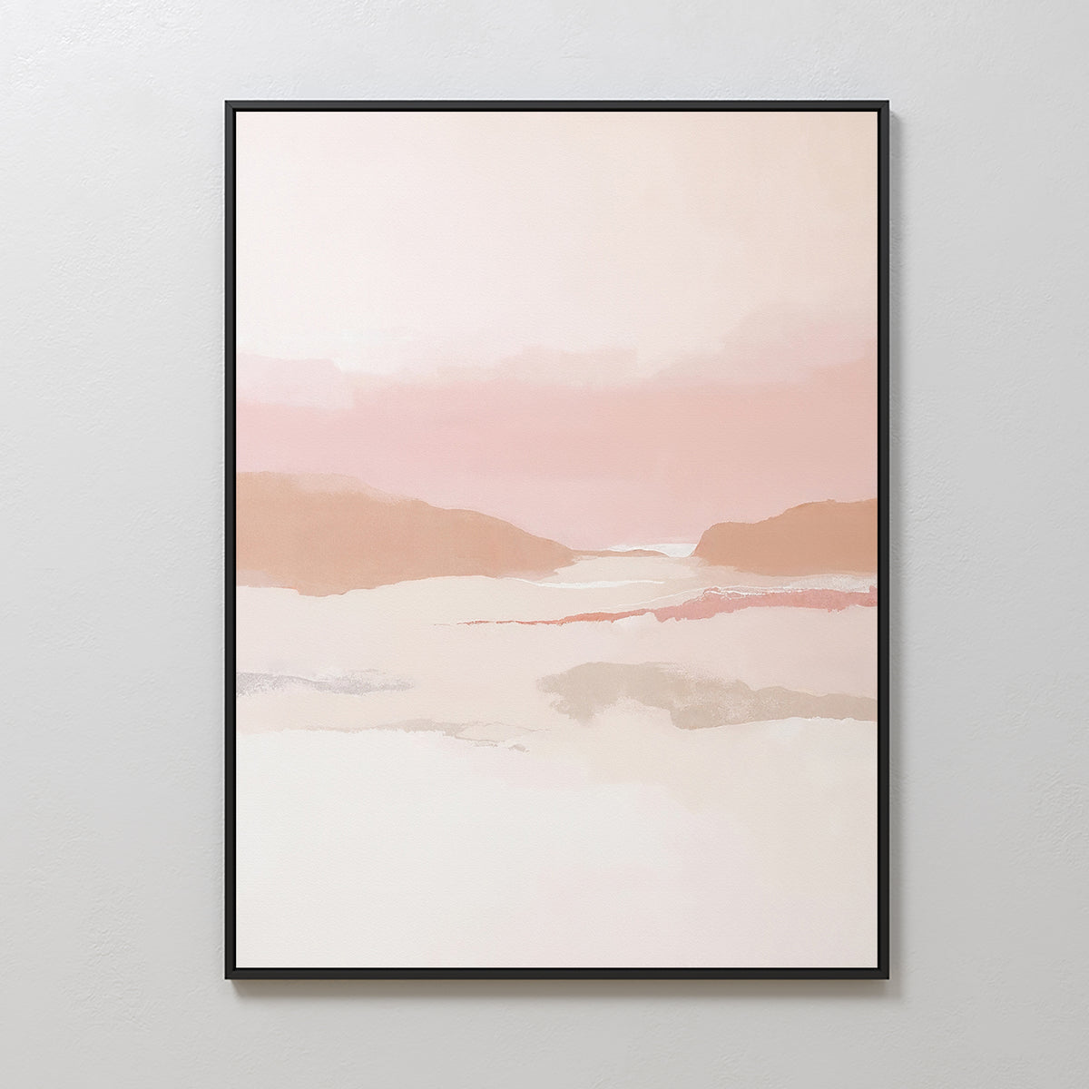 The Blush Mesa Canvas Art - Vertical, a framed minimalist piece with soft pink, peach, and beige tones evoking gentle hills and a tranquil sky, is displayed on a plain white wall.