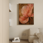 The Blush Petals Abstract Canvas Art, featuring a large pink flower with soft petals, is displayed above a light-colored couch on a beige wall, with a wooden shelf holding books and decor visible to the left.