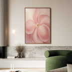 A living room featuring the Blushing Magnolia Canvas Art - Vertical, a green curved sofa, a vase with dried branches on a marble shelf, and neutral décor in earthy tones creates a softly romantic atmosphere.