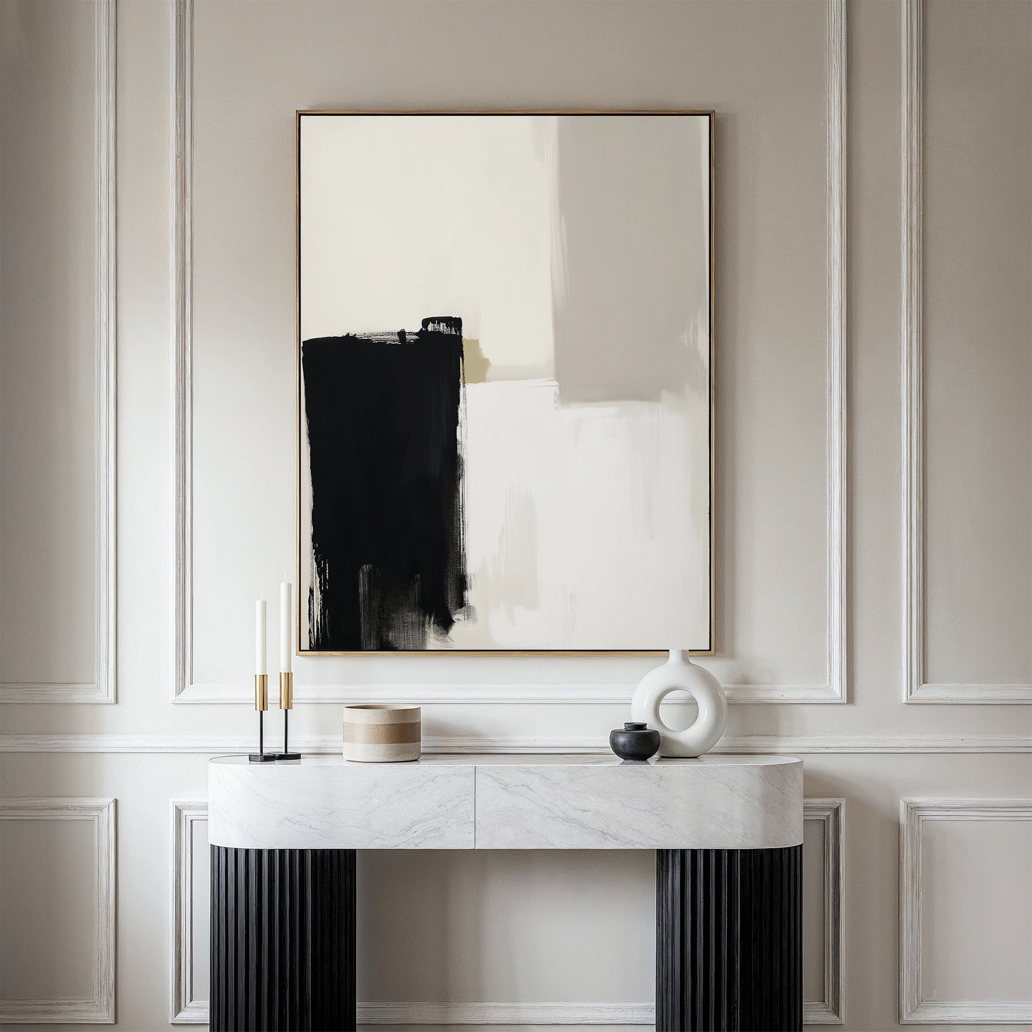 The Bold Division Canvas Art - Vertical, featuring black, white, and beige tones in a gold frame, hangs above a modern console table with decorative accents against a light-colored wall—perfect for stylish living rooms.