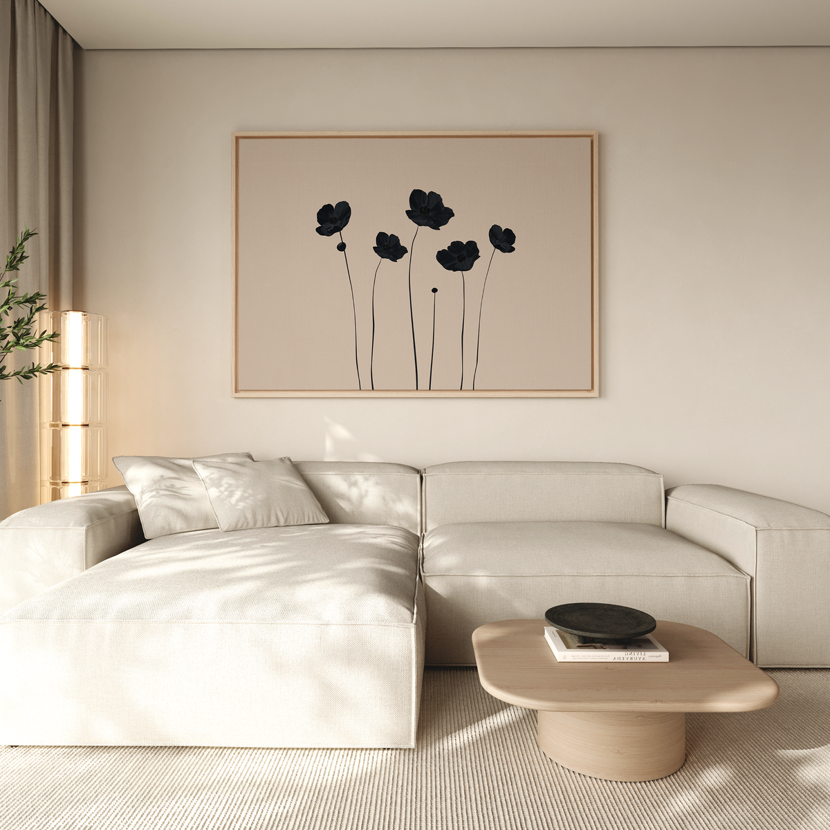 A modern living room with a light beige sectional, low wooden coffee table with books and a dark bowl, and Botanic Abstract Canvas Art featuring minimalist black flowers on a light background. Neutral tones and soft lighting complete the scene.
