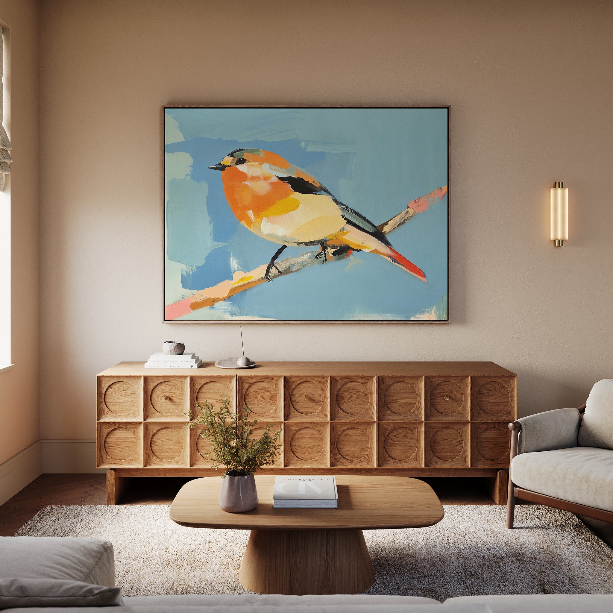 A modern living room with light walls, a wooden sideboard, and the Bright Songbird Canvas Art - Horizontal displayed above. A round coffee table with a vase of flowers sits on a light rug between two light-colored sofas.