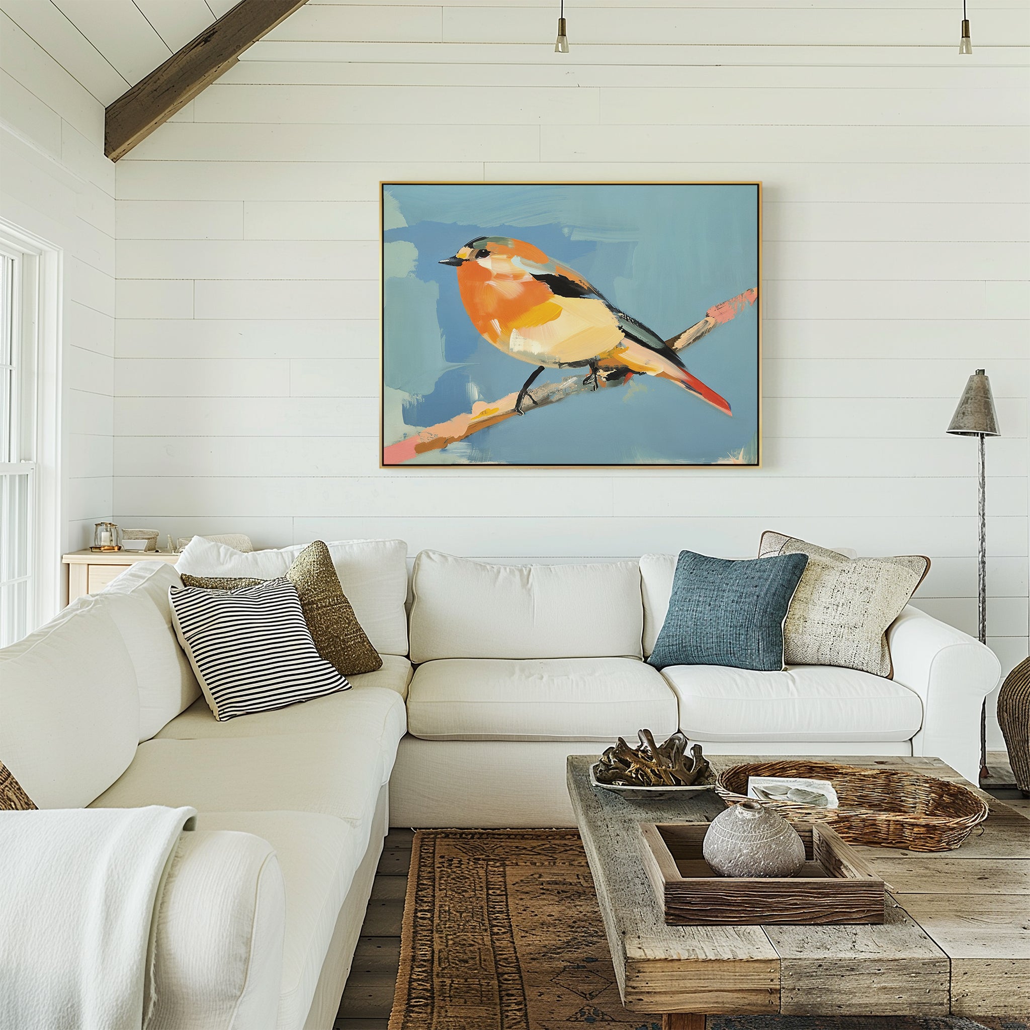 Bright, airy living room with a white sectional sofa, textured pillows, rustic coffee table, and the Bright Songbird Canvas Art - Horizontal on the white shiplap wall above the couch. Natural light streams in from the left.