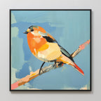The Bright Songbird Canvas Art - Square features a small bird with orange, yellow, and black feathers on a branch set against a light blue abstract background, beautifully framed in black.