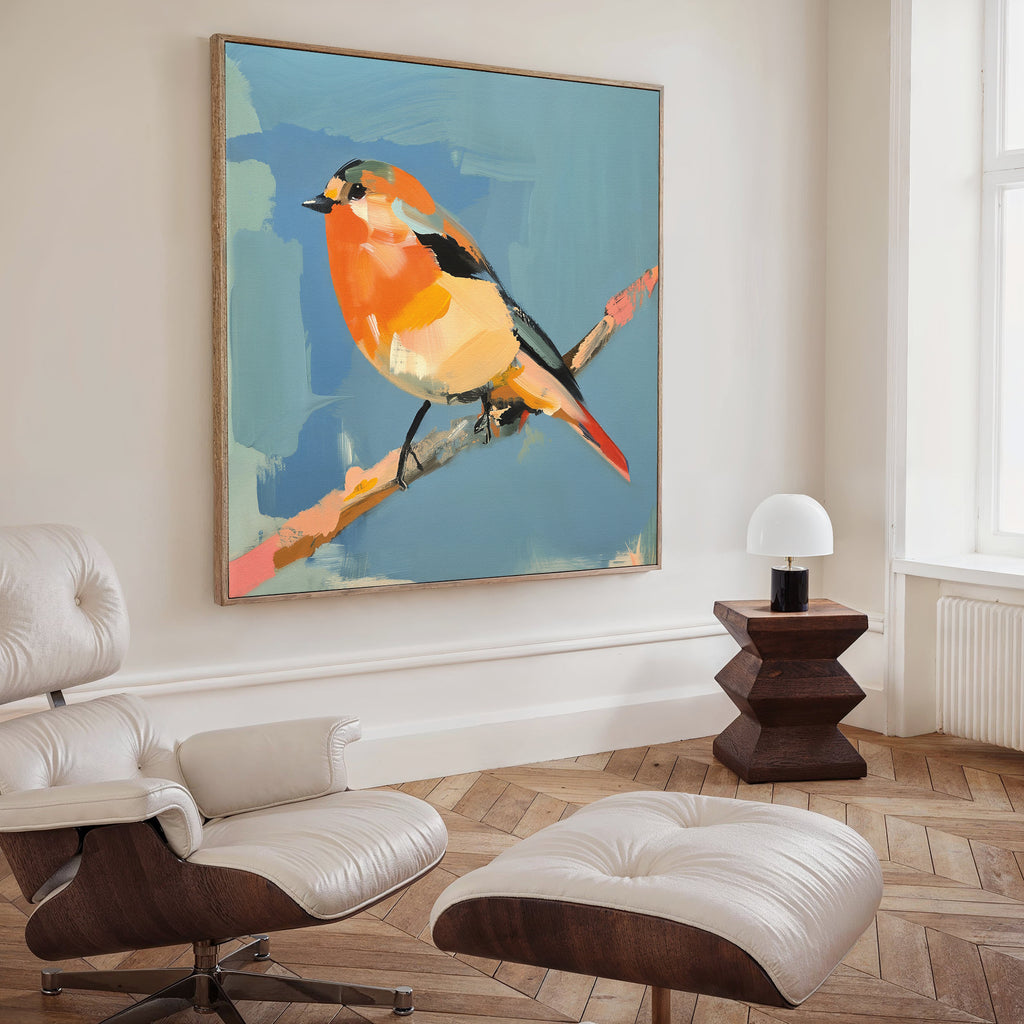 A modern living room with a leather lounge chair and ottoman, a geometric wooden side table with a lamp, and the Bright Songbird Canvas Art - Square adds vibrant character with its colorful bird on a branch.