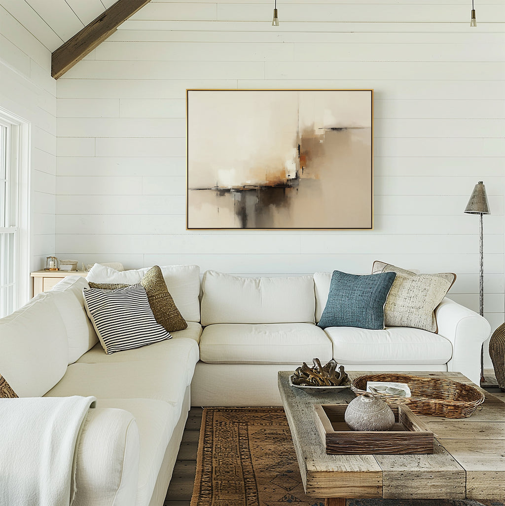 A cozy living room features white shiplap walls, two white sofas with assorted pillows, a rustic wooden coffee table, and the Burnt Sienna Convergence Canvas Art - Horizontal hanging above the seating area. Natural light fills the space.