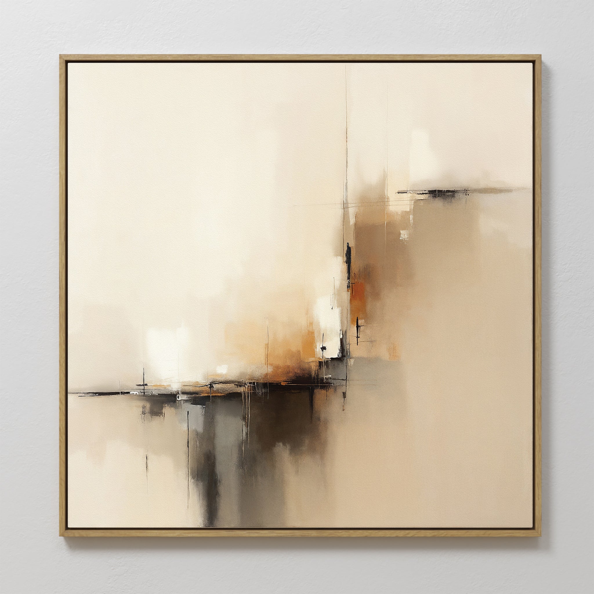 The Burnt Sienna Convergence Canvas Art - Square features a contemporary mix of beige, cream, brown, and black brushstrokes. Framed in thin gold, this elegant wall art adds a soft, modern touch to any light-colored room.