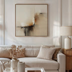 A modern living room features a beige sofa, matching cushions, a side table with a white lamp, dried flowers in a vase, and the Burnt Sienna Convergence Canvas Art - Square—perfect for achieving that Nordic Park-inspired ambiance.