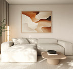 A modern living room featuring a light beige sectional sofa, low wooden coffee table with a black bowl, tall plant, and the Canyon Curves Canvas Art - Horizontal in warm earth tones on a neutral-colored wall.