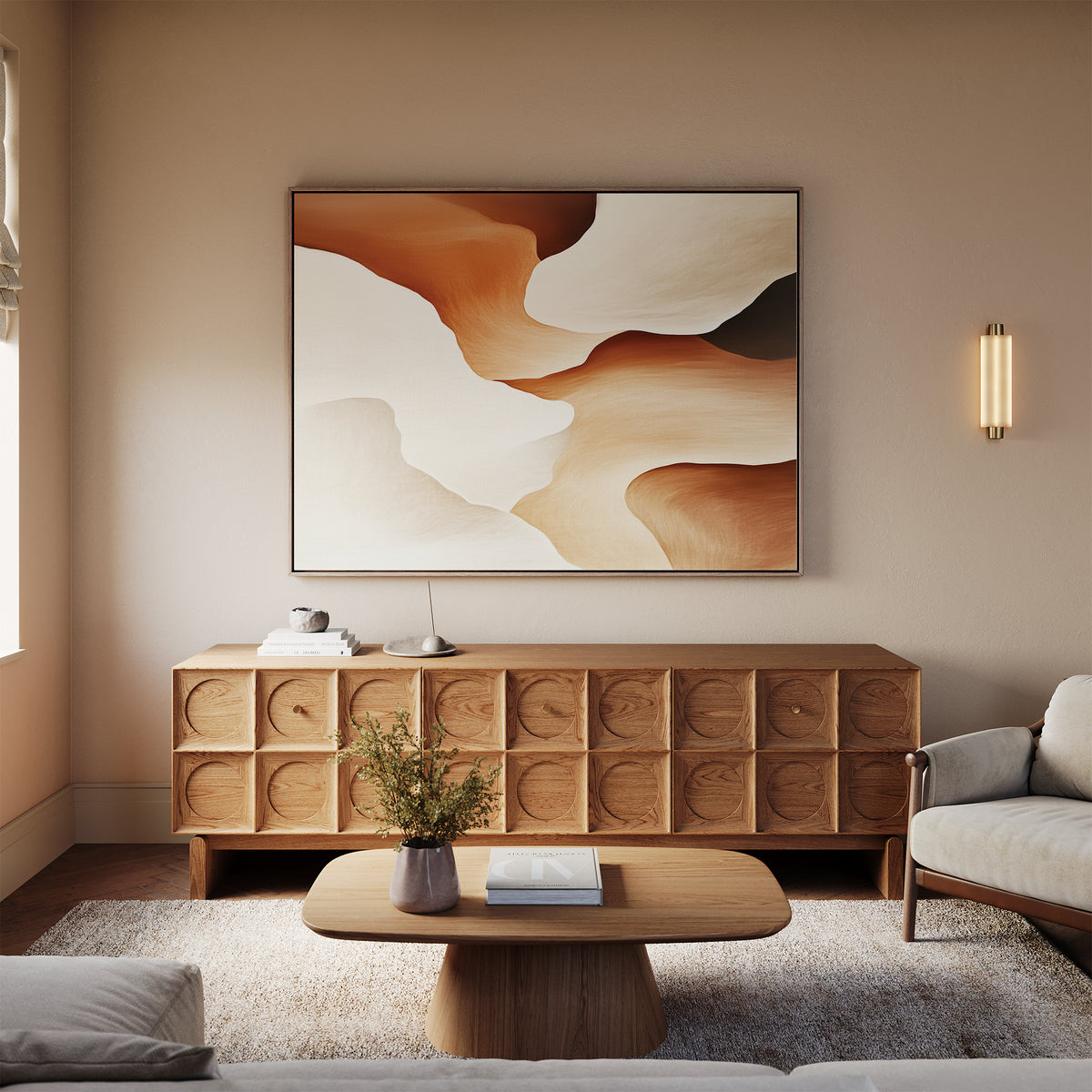 A modern living room featuring a light beige sofa, wooden coffee table, textured sideboard, and the Canyon Curves Canvas Art - Horizontal adds warmth and style, highlighted by soft natural lighting and a sleek wall-mounted light fixture.