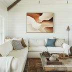 A bright, cozy living room with a white sectional sofa, assorted pillows, a rustic wooden coffee table, and the Canyon Curves Canvas Art - Horizontal in warm earth tones on a shiplap-paneled wall.