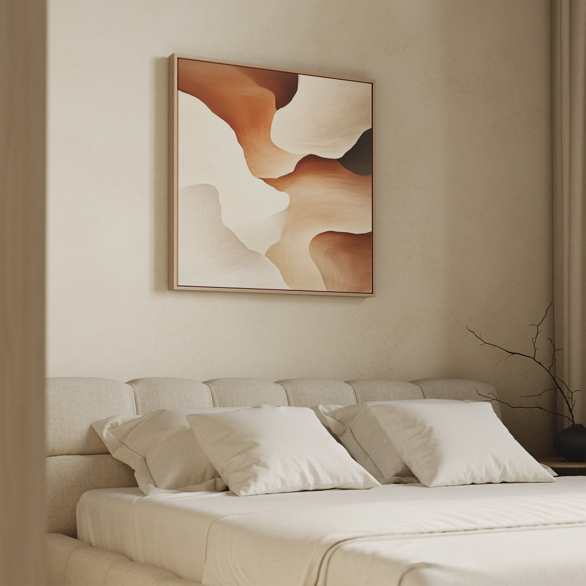 A modern bedroom with a beige upholstered bed, white pillows, and the Canyon Curves Canvas Art - Square in earth tones above the headboard. A minimalist vase with branches is on the bedside table.