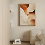 A neutral living room features a light beige sofa, minimalist shelving, and the Canyon Curves Canvas Art - Vertical with earthy brown and cream swirls. A small decorative object on the bottom shelf completes this serene modern space.