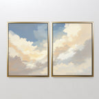 Celestial Embrace - Set of 2 features framed canvas prints displaying soft clouds in blue and gold hues. This Nordic Park-inspired wall art brings a serene, calming touch to any white wall.
