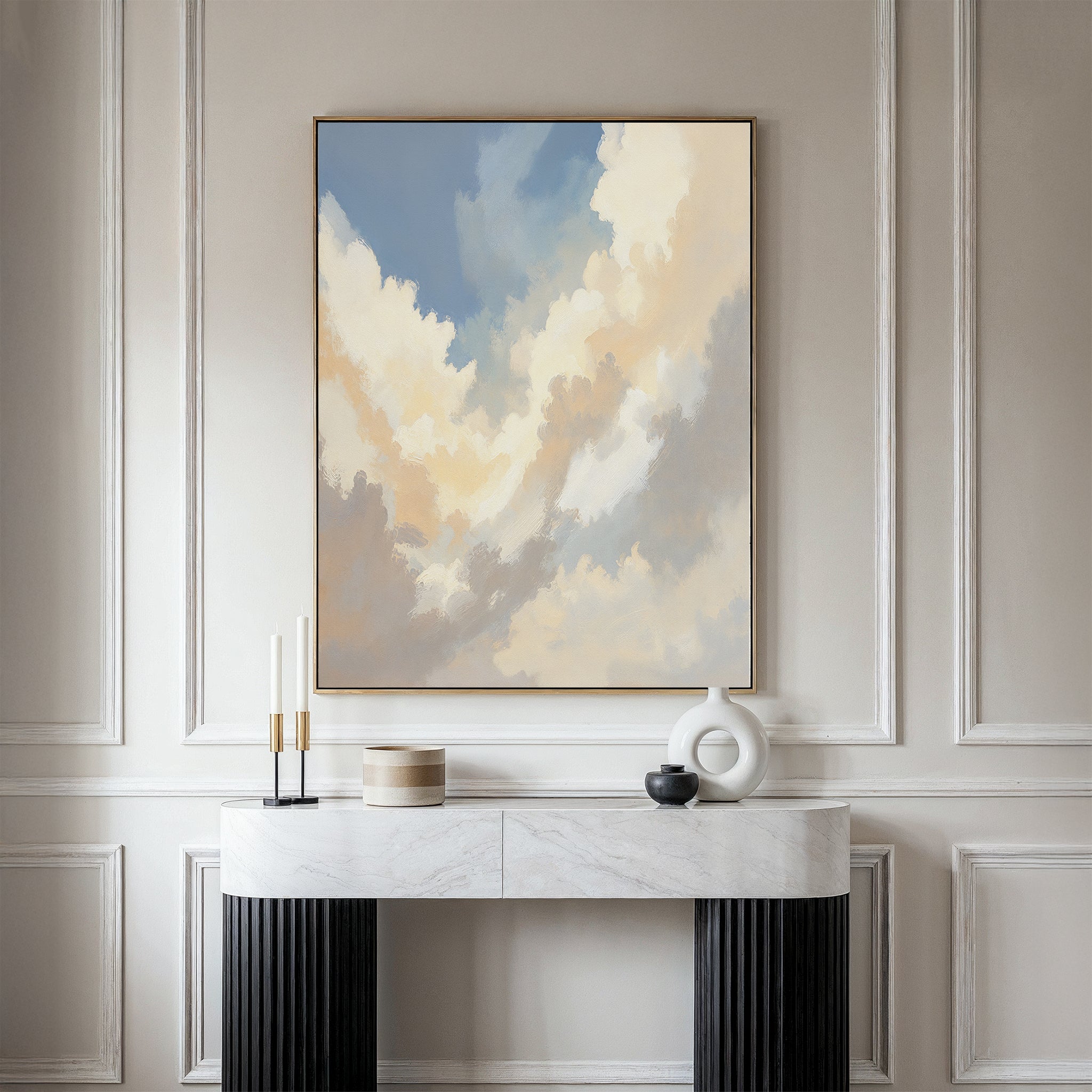 A modern entryway with a white marble console table, decor accents, and the Celestial Embrace Canvas Art - Vertical featuring soft blue and cream clouds on a neutral paneled wall.
