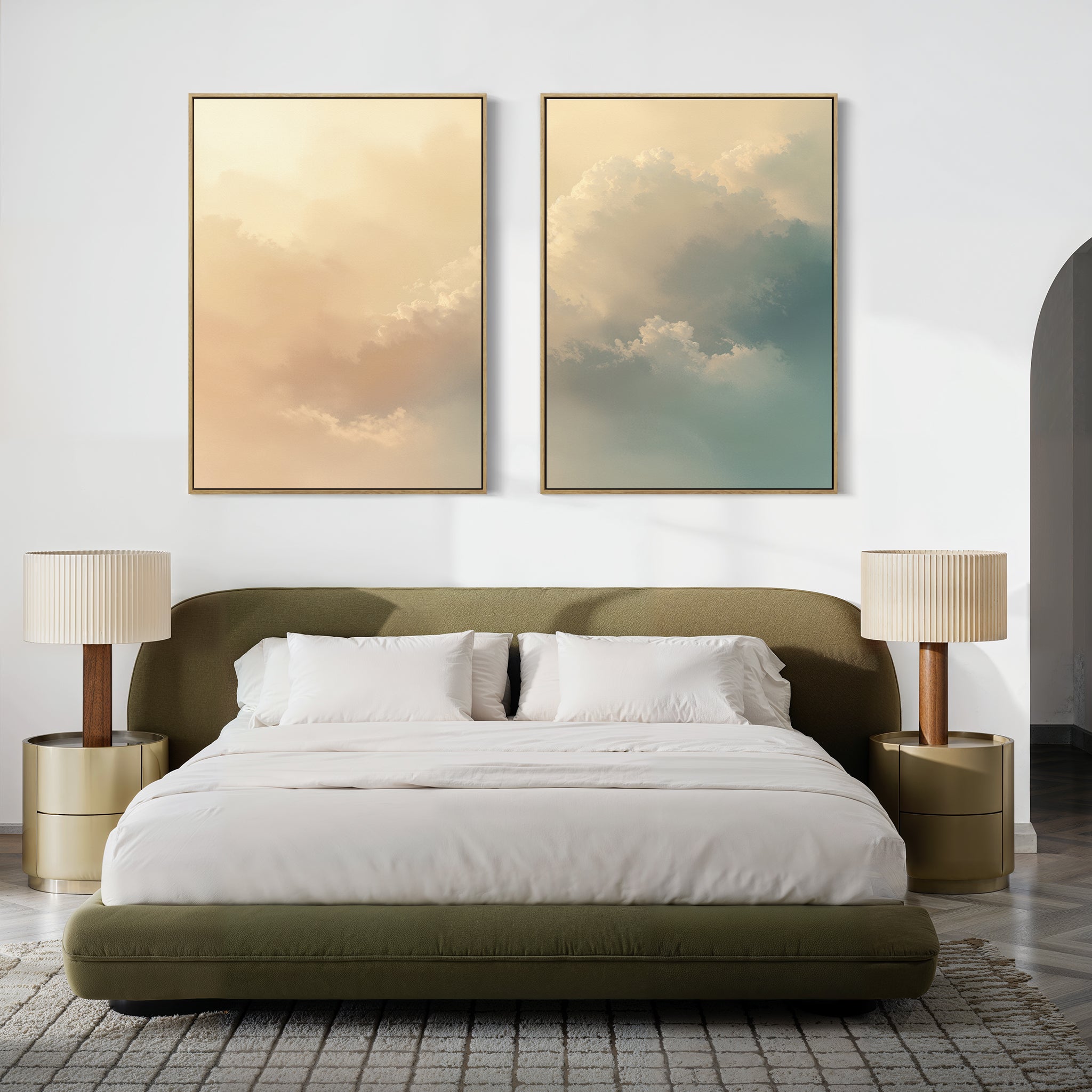 A modern bedroom with a green upholstered bed, white bedding, two gold nightstands with champagne-lit lamps, and two large Celestial Veil - Set of 2 cloud-themed canvas prints above the headboard.