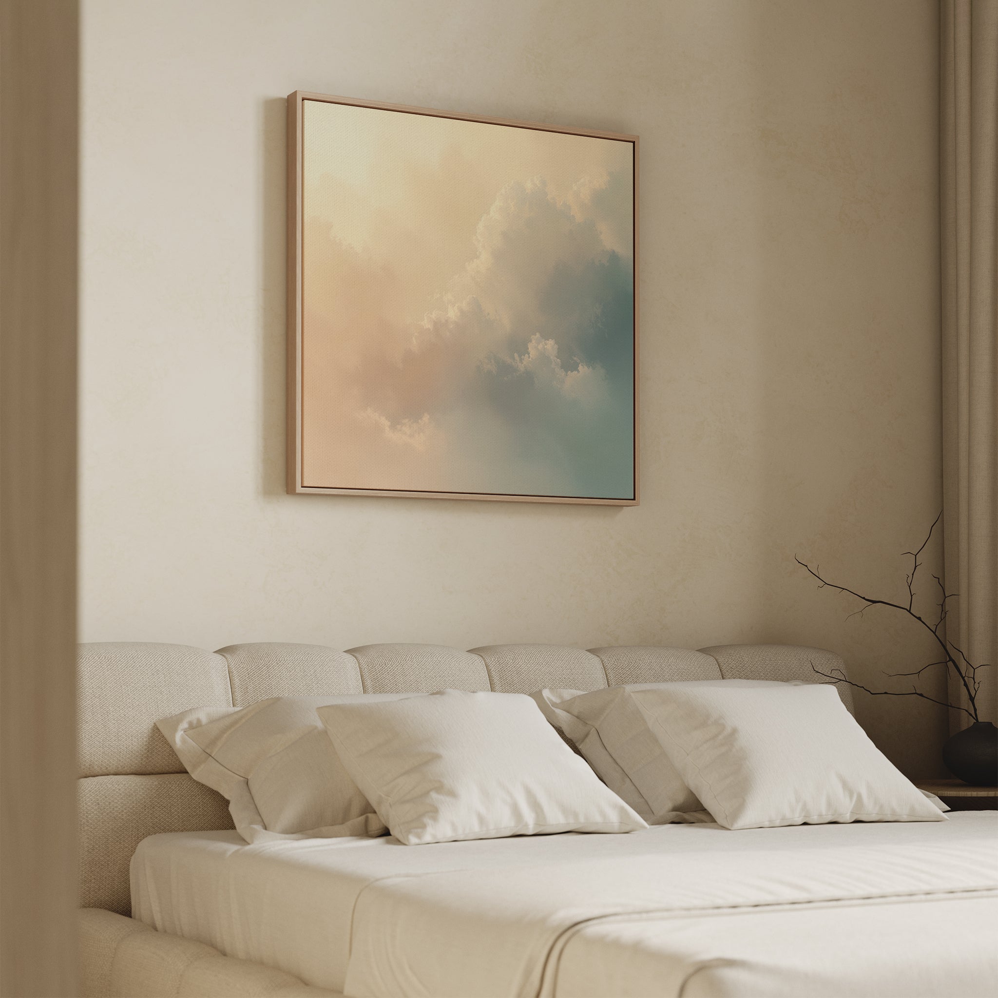 A minimalist bedroom features a beige upholstered bed with white linens. Above the bed hangs the Celestial Veil Canvas Art - Square, showcasing soft, pastel clouds. A simple branch accents the nightstand.