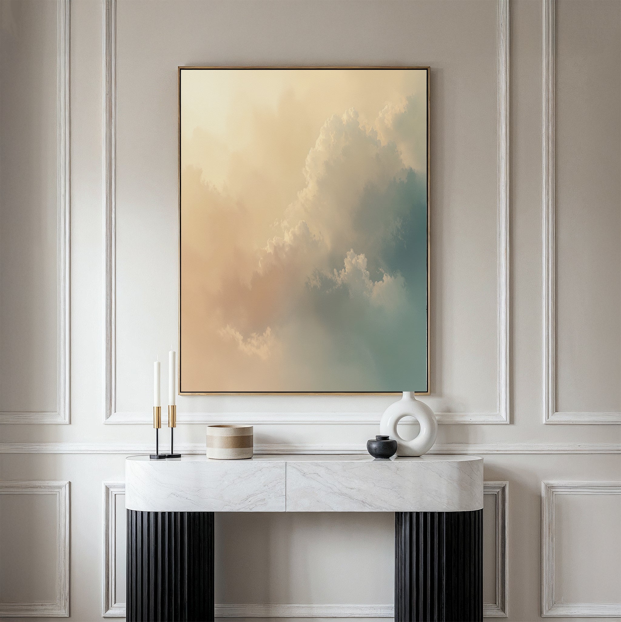 A minimalist interior showcases a marble console table, decorative objects, and the Celestial Veil Canvas Art - Vertical, featuring soft pastel clouds illuminated by champagne light, displayed on a beige paneled wall.