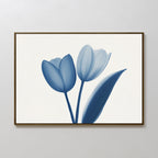 The Cerulean Tulips Canvas Art - Horizontal, featuring long-stemmed tulips on a white background and inspired by the calm of Nordic Park, adds a serene touch when displayed on a light-colored wall.