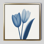 The Cerulean Tulips Canvas Art - Square features two blue tulips with a single leaf on a white background, framed in gold—ideal for adding Nordic Park style and minimalist charm to your space.
