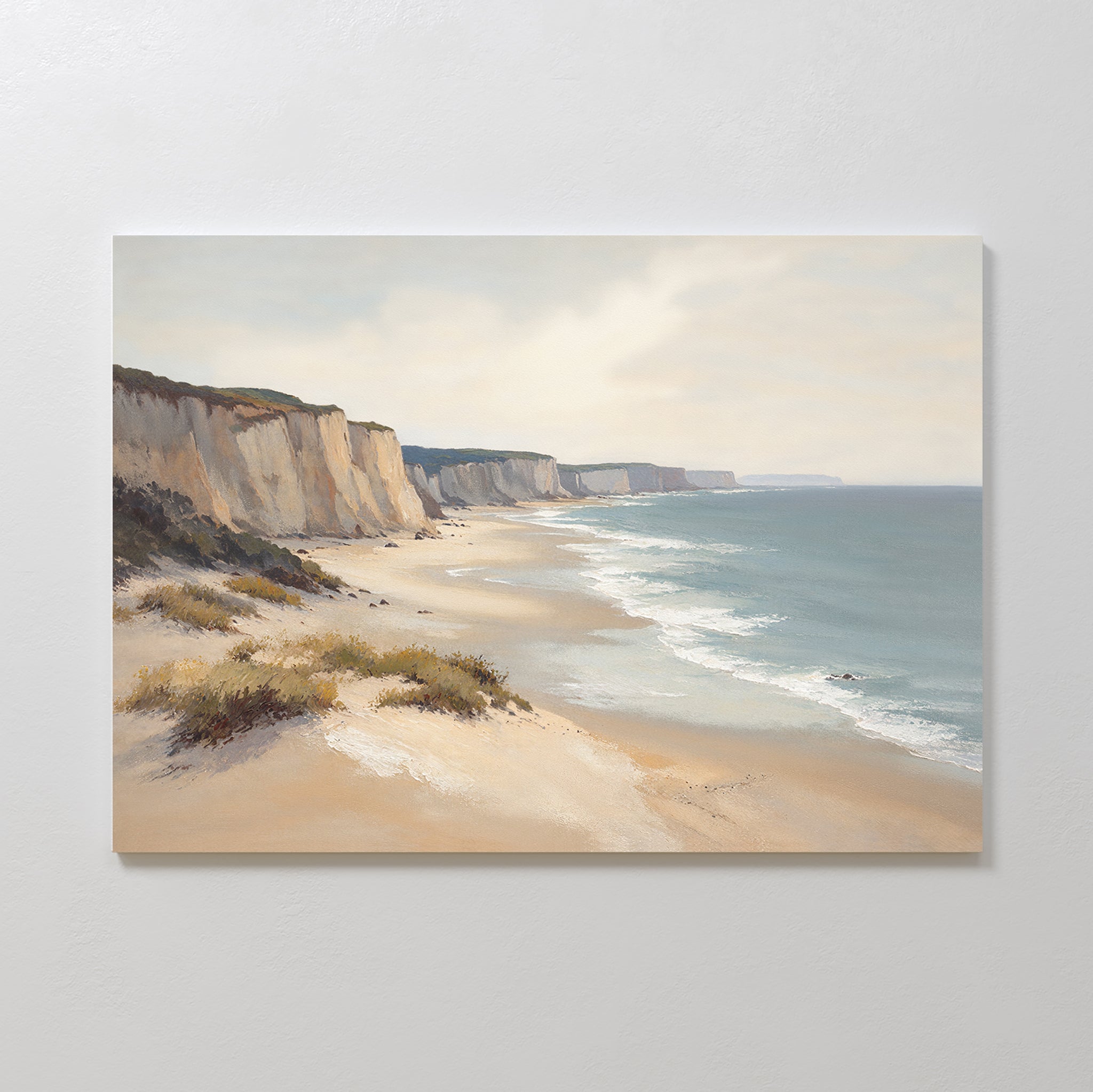 Chalk Shores Canvas Art - Horizontal: A canvas print of a coastal landscape with sandy beach, gentle waves, white cliffs under a cloudy sky, and sparse vegetation in the foreground. Ideal as coastal wall art or seaside decor.