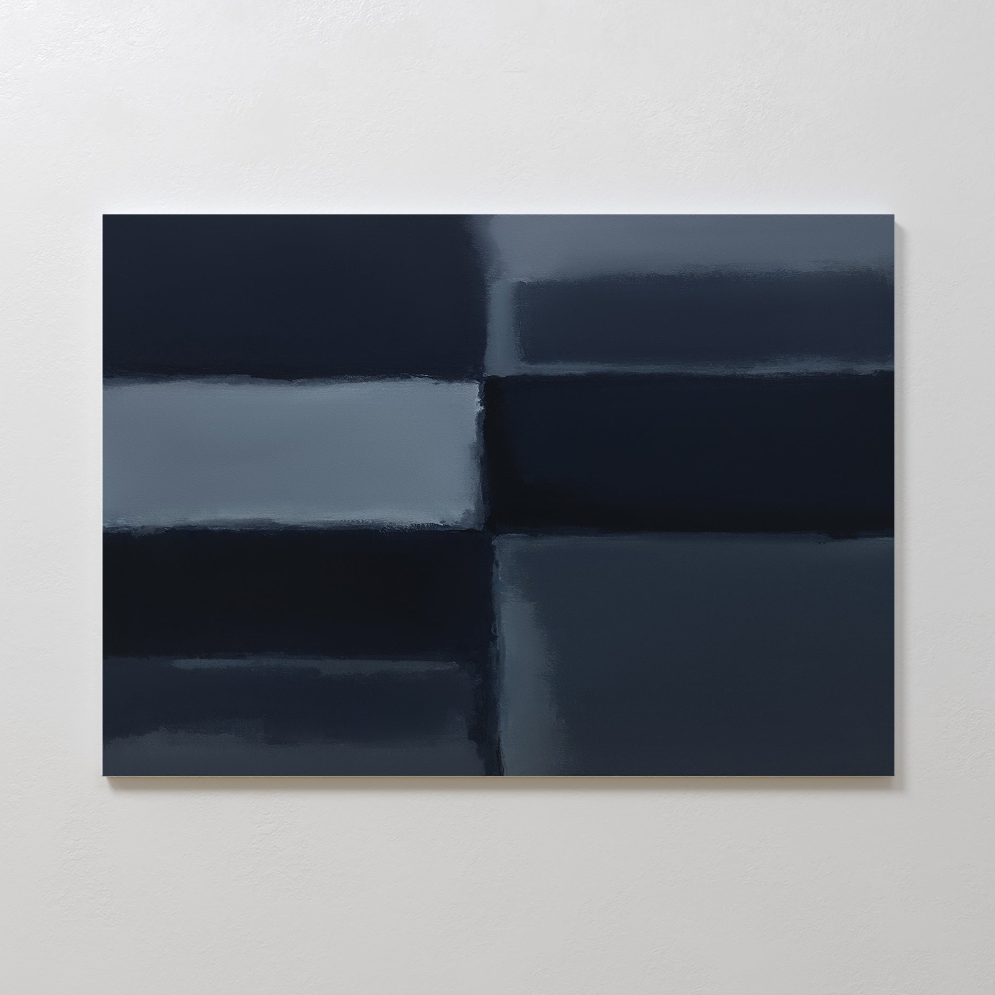 The Charcoal Blocks Canvas Art - Horizontal features four large, blurred geometric blocks in dark blue and gray, creating a striking, modern accent for any living room when displayed on a light-colored wall.