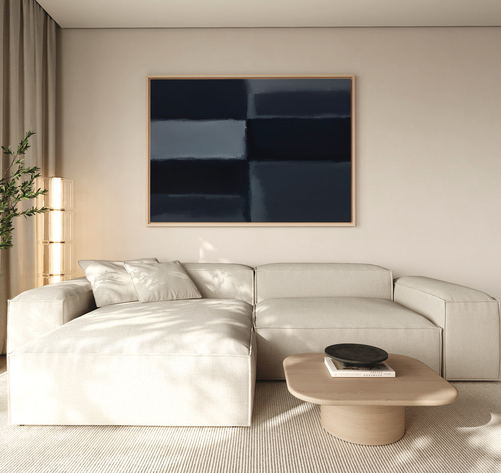 Minimalist living room with a light beige sectional, low wooden coffee table, black bowl, tall plant, and Charcoal Blocks Canvas Art - Horizontal featuring dark blue and black rectangles as modern decor.