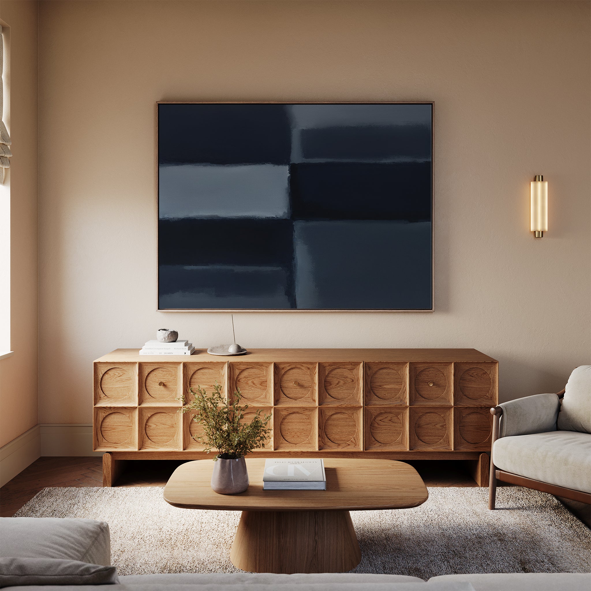 A modern living room featuring a light sofa, wooden coffee table, and carved wooden sideboard. Above the sideboard hangs the Charcoal Blocks Canvas Art - Horizontal, while a wall sconce bathes the space in warm light.