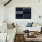 A bright living room with white shiplap walls, a large white sectional sofa, rustic wood coffee table, and modern decor featuring the Charcoal Blocks Canvas Art - Horizontal hung above the sofa.