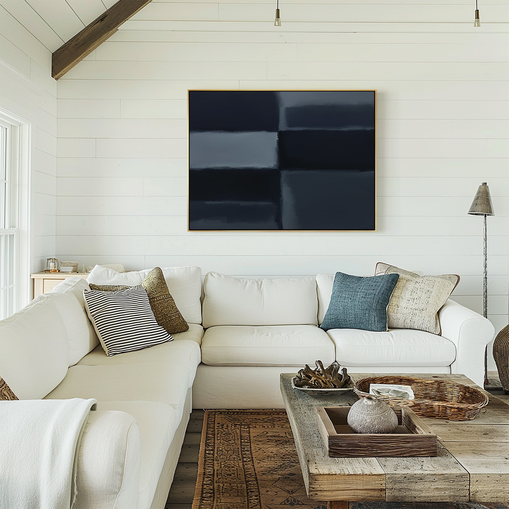 A bright living room with white shiplap walls, a large white sectional sofa, rustic wood coffee table, and modern decor featuring the Charcoal Blocks Canvas Art - Horizontal hung above the sofa.