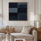 A modern living room with a beige sofa, neutral cushions, a wooden side table, white lamp, dried flowers in vases, and the Charcoal Blocks Canvas Art - Square hanging above as a minimalist print—perfect for contemporary decor.