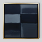 Charcoal Blocks Canvas Art - Square features intersecting dark blue and gray rectangles with soft, blurred edges for depth. Framed in slim metallic gold, it's an ideal minimalist print for modern decor. Shown on a light gray wall.