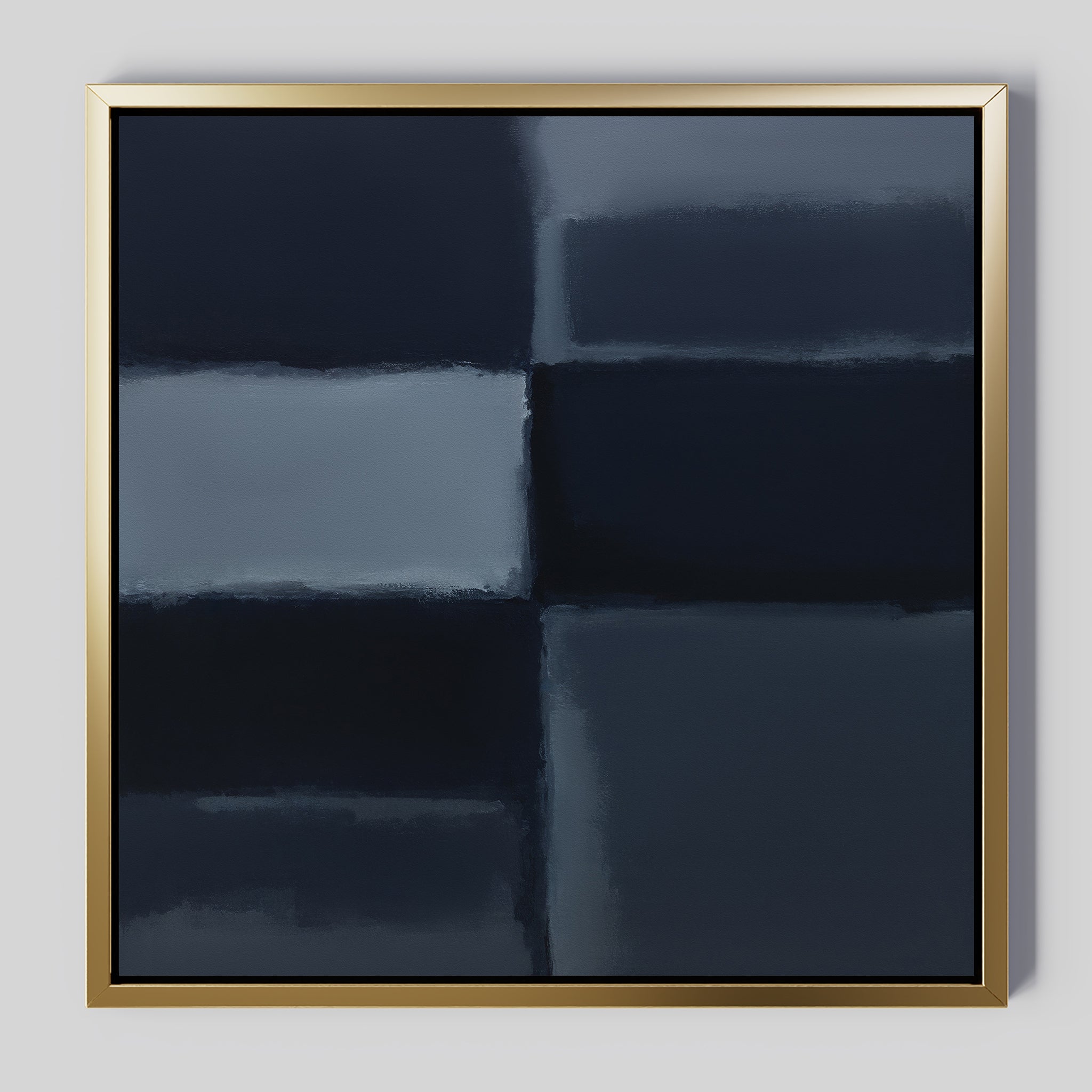 Charcoal Blocks Canvas Art - Square features intersecting dark blue and gray rectangles with soft, blurred edges for depth. Framed in slim metallic gold, it's an ideal minimalist print for modern decor. Shown on a light gray wall.
