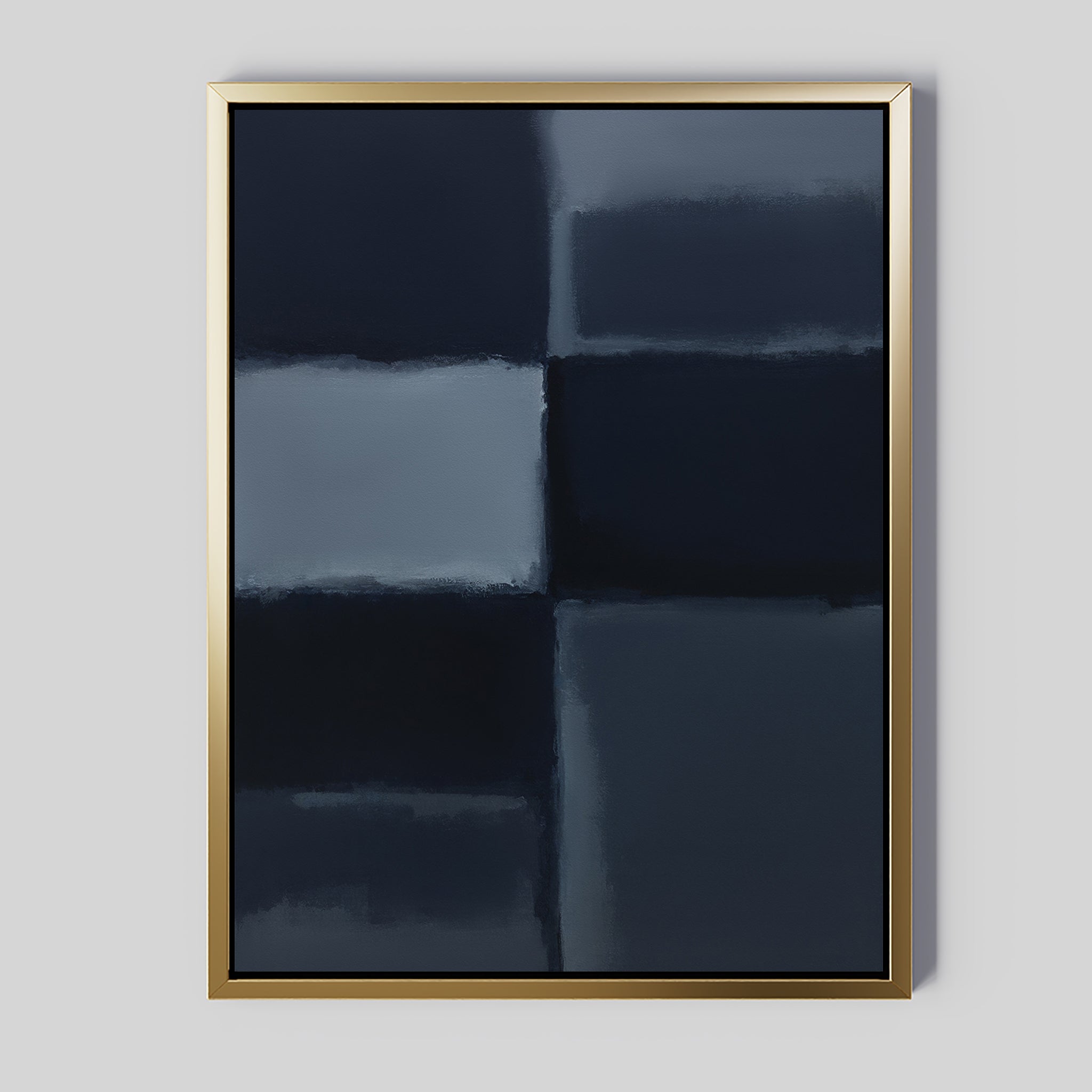 The Charcoal Blocks Canvas Art - Vertical features four dark blue and black rectangles with blurred edges, set on a light gray wall. A metallic gold frame adds elegance to this minimalist wall art piece.