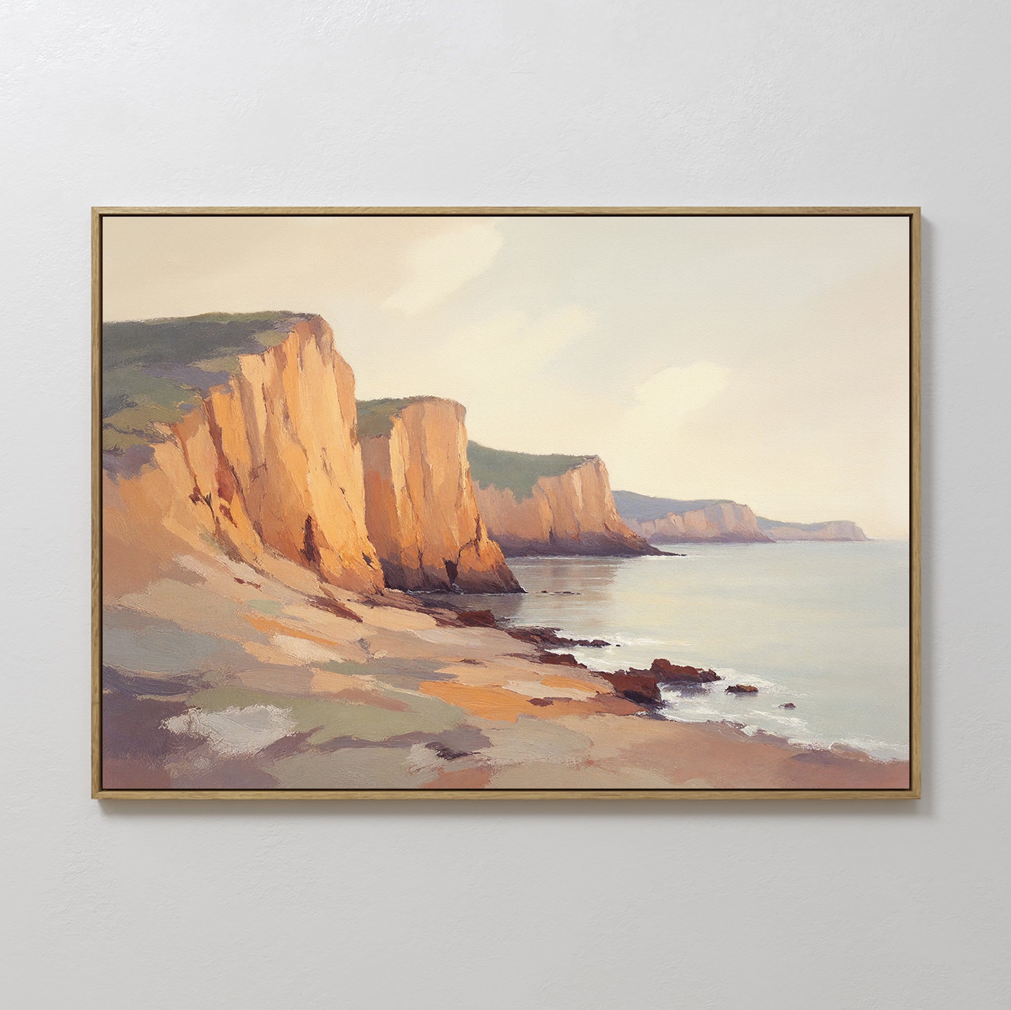 The Coastal Grandeur Canvas Art - Horizontal features cliffs at sunset with warm light on rocky formations and calm shoreline waves under a pale sky—ideal seaside wall art for any space.