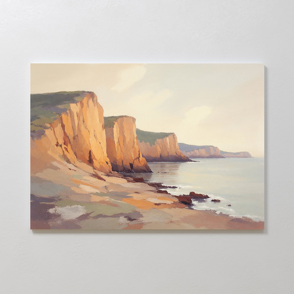 The Coastal Grandeur Canvas Art - Horizontal depicts sunlit coastal cliffs with green tops above a calm sea, rocky shore, and pastel sky, creating tranquil seaside wall art that captures the peaceful beauty of nature by the water.