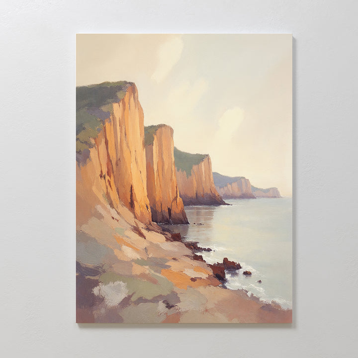 Experience breathtaking seaside cliffs lit by gentle sunlight in the Coastal Grandeur Canvas Art - Vertical. Rugged rocks and a calm sea create a serene, striking coastal wall art piece perfect for any space.