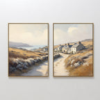 Coastal Haven - Set of 2: Framed landscape prints feature winding country roads, cottages, golden fields, and coastal cliffs under a sunlit, partly cloudy sky—capturing rustic charm and inviting tranquility.