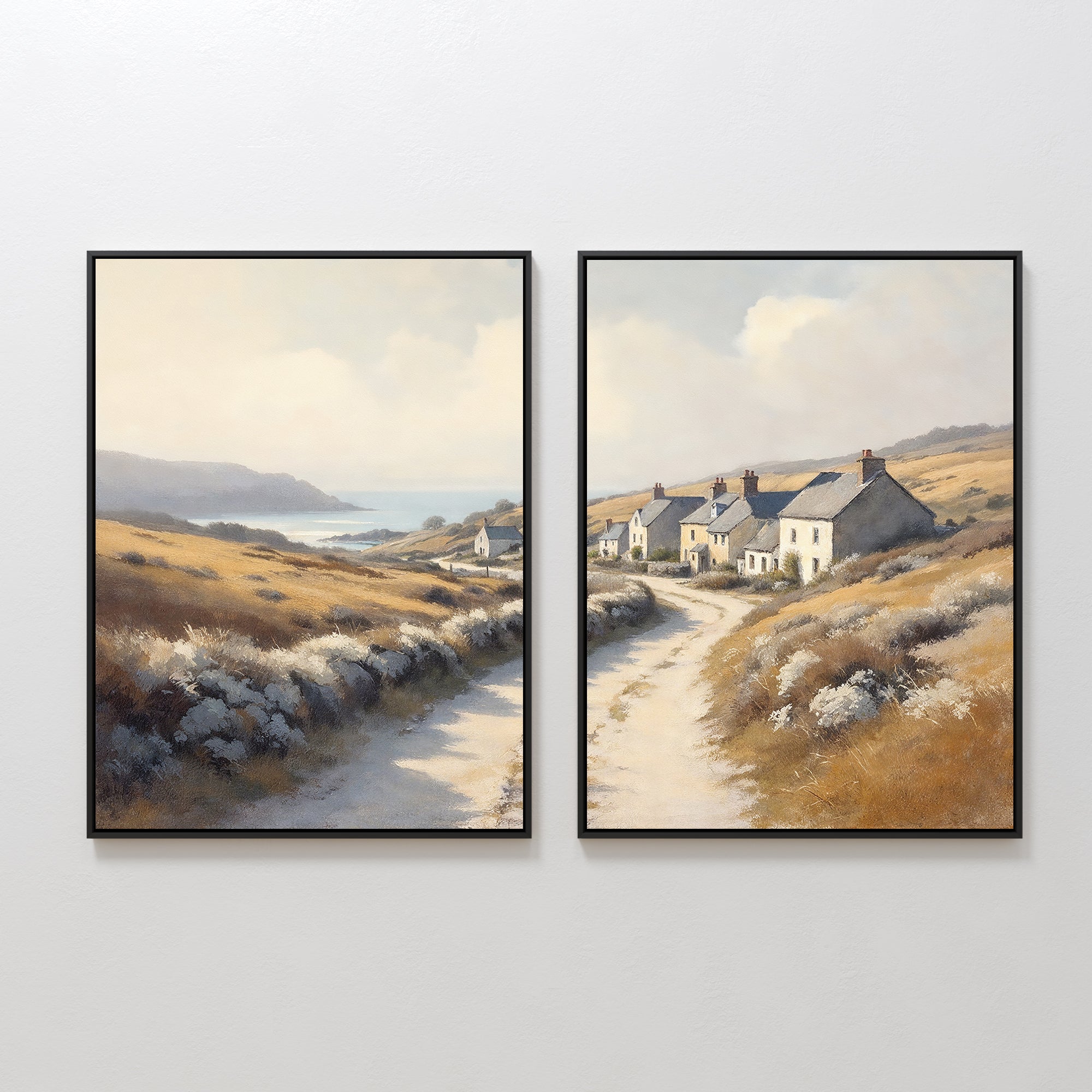 The Coastal Haven - Set of 2 features framed prints of rustic landscapes: one with a winding road to the sea, and the other showcasing white cottages along golden fields beneath a bright sky.