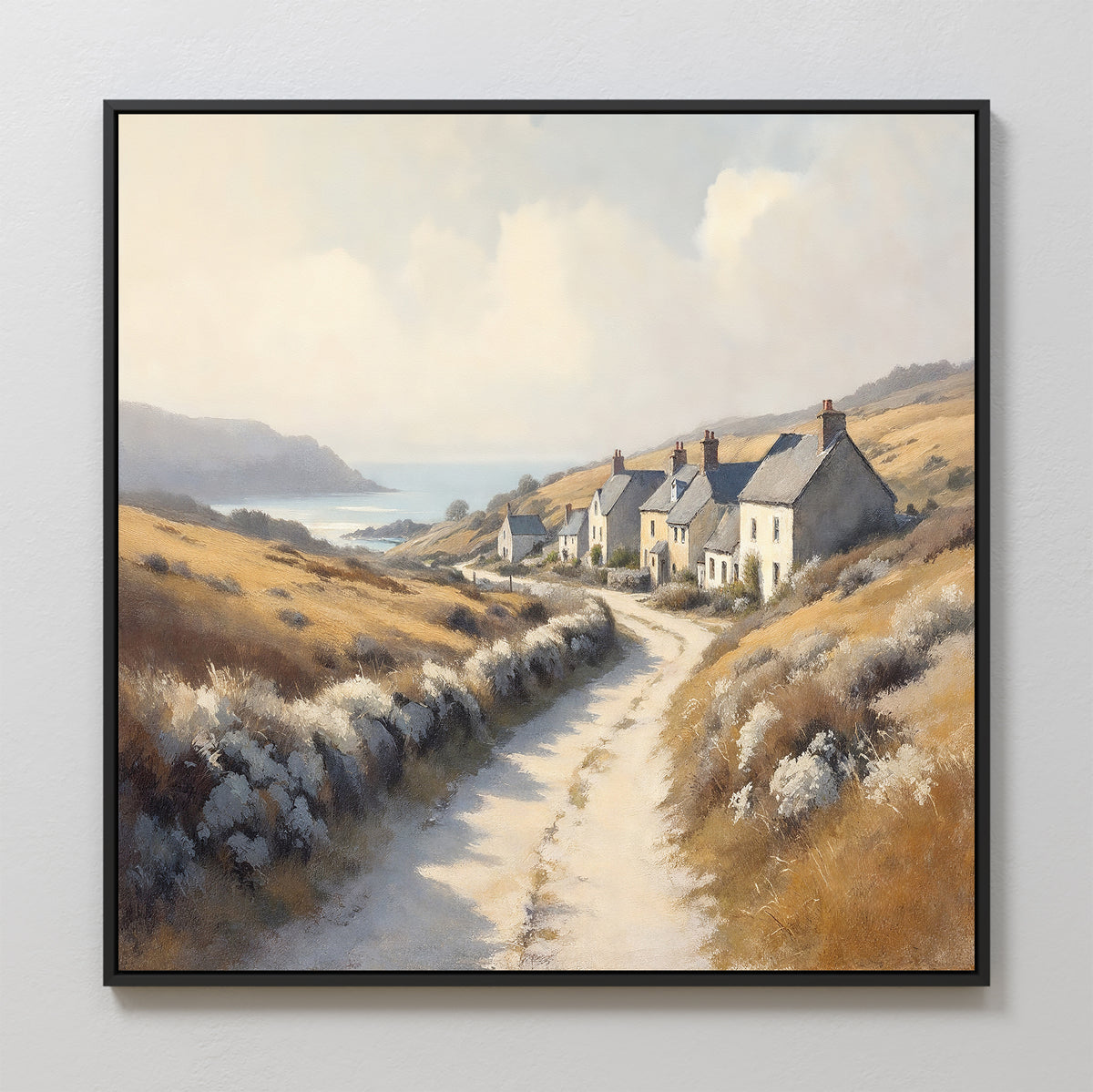 The Coastal Haven Canvas Art - Square features a winding dirt path to cottages amid golden fields and shrubs, with hills and the sea in the distance beneath a partly cloudy sky—a charming rustic wall art piece.