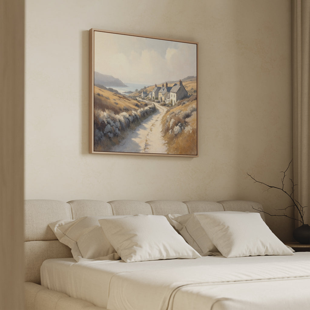 A cozy bedroom features a beige bed with white pillows and the "Coastal Haven Canvas Art - Square" above the headboard, adding minimal, soft-toned décor with rustic charm.