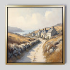 The Coastal Haven Canvas Art - Square features a rural landscape with a winding dirt road, cottages, golden fields, hills, and a distant sea beneath a cloudy sky—ideal rustic wall art to enhance your home décor.
