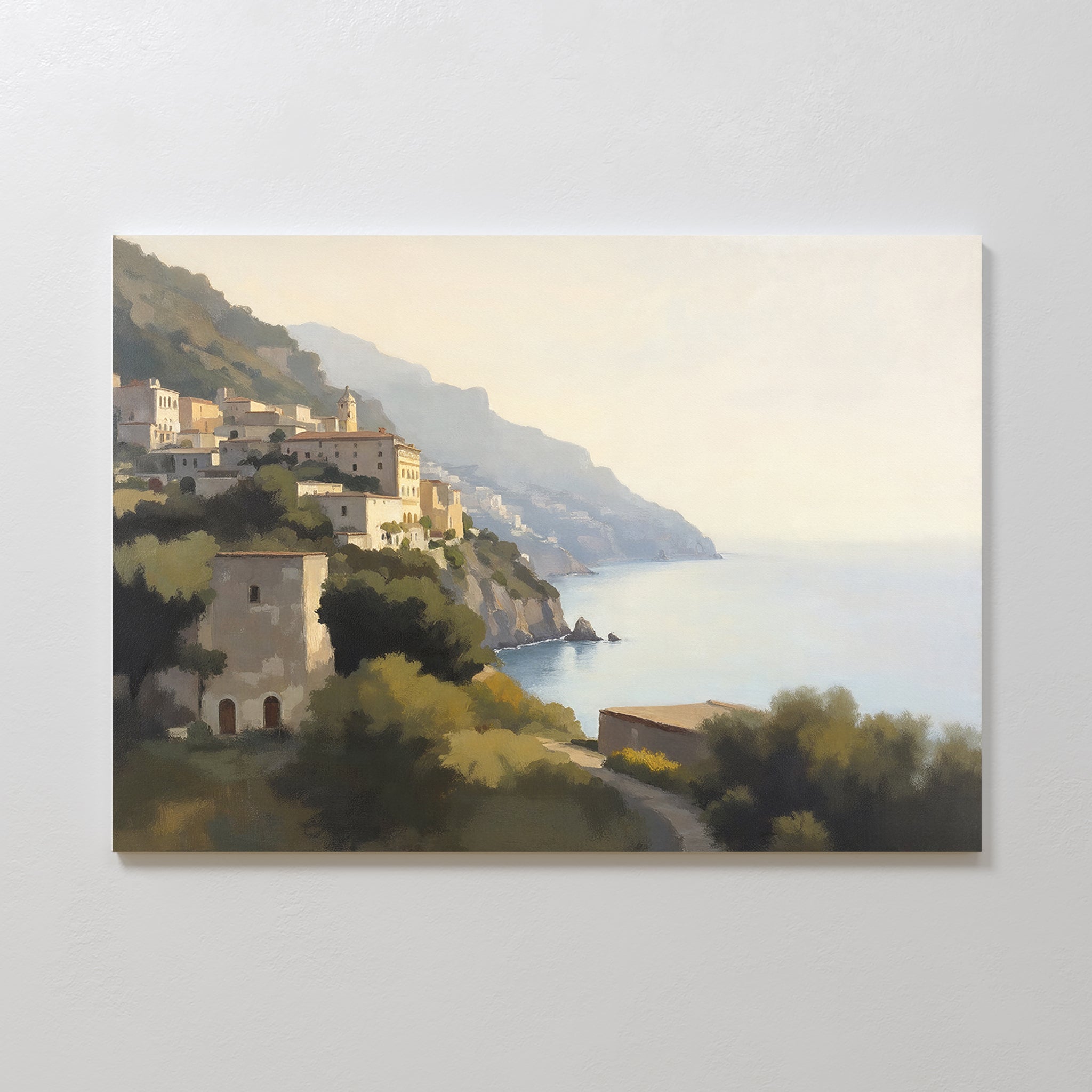 Italian Reverie Canvas Art - Horizontal captures a sunlit coastal village with cliffside architecture, mountains, and trees overlooking a calm sea beneath a soft, hazy sky.