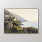 The Italian Reverie Canvas Art - Horizontal features a framed Mediterranean scene with cliffside architecture, a tranquil sea, sunlit buildings, lush greenery in front, and distant mountains fading into the background.