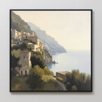 The Italian Reverie Canvas Art - Square features a framed Mediterranean scene of a hillside coastal village with historic buildings, lush greenery, and a sunlit sea—perfect as elegant home decor or eye-catching coastal wall art.